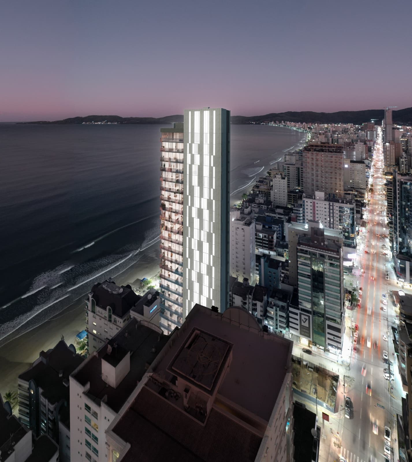 Torre do Elysium Residence à beira-mar, com a orla de Itapema ao entardecer