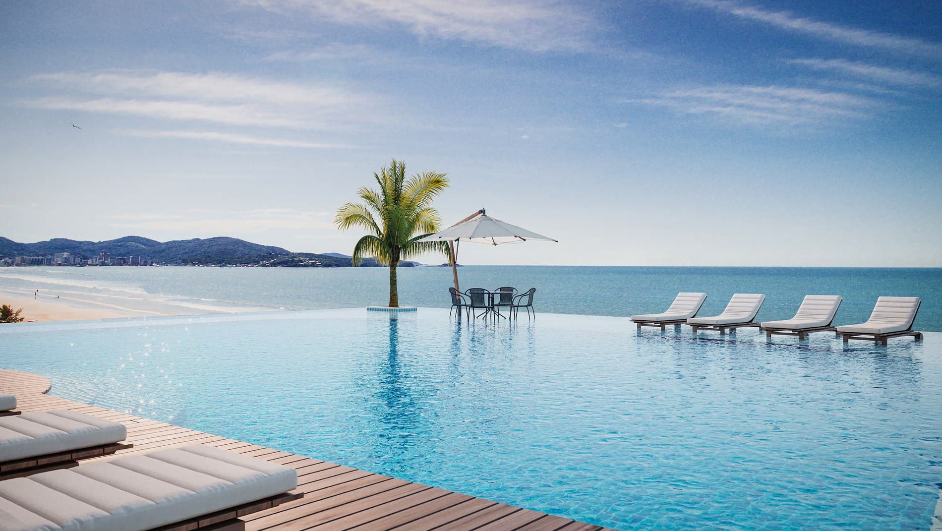 Piscina com borda infinita do Enseada Residence, de frente para o mar