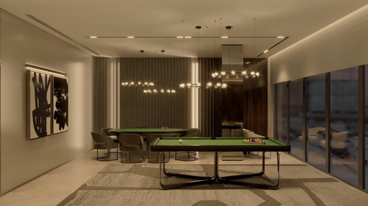 Salão de jogos do Evolution Residence com sinuca e mesa de carteado