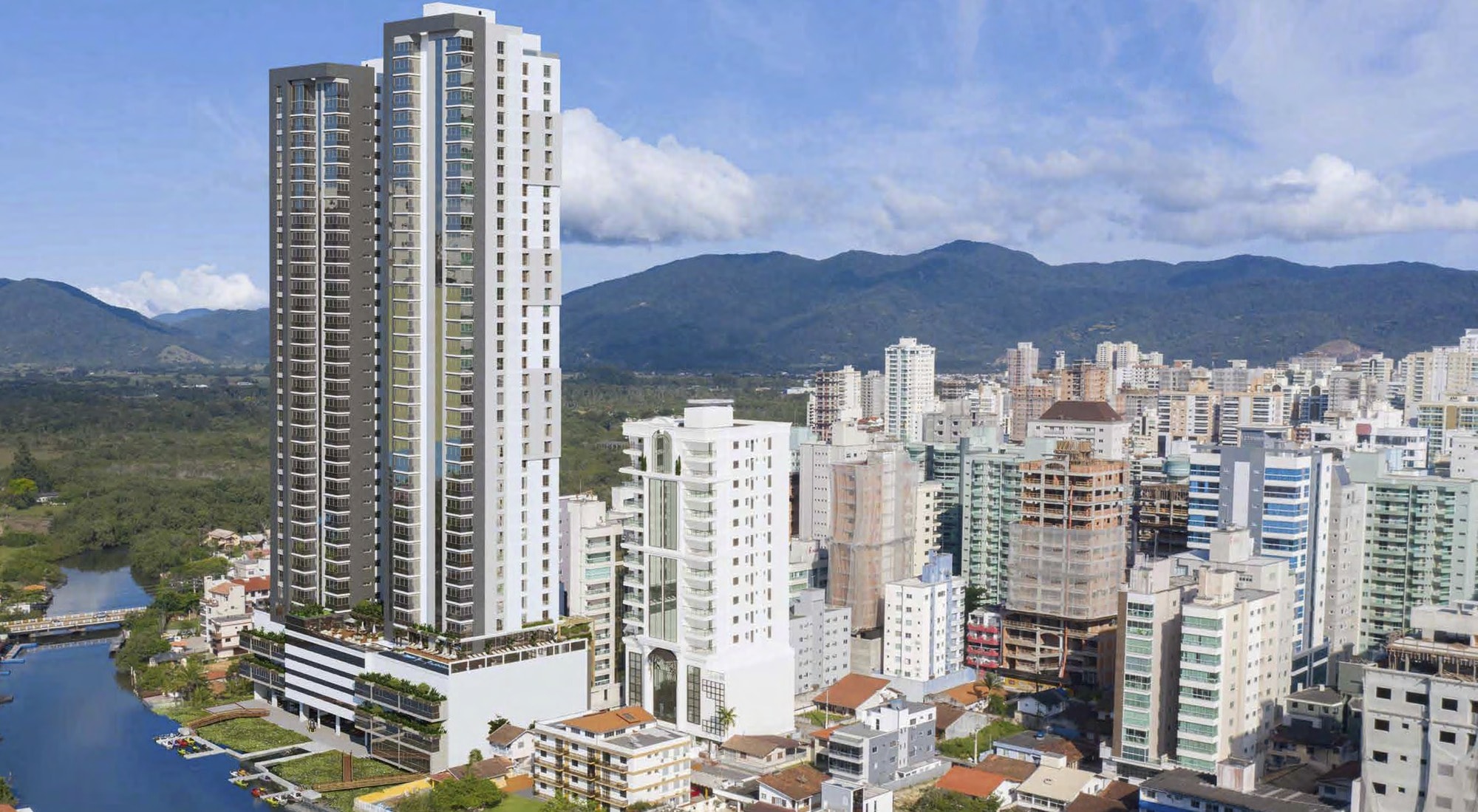As duas torres do Ocean Hill Residence, na Rua 321, Meia Praia, Itapema, com o Rio Perequê e a serra ao fundo